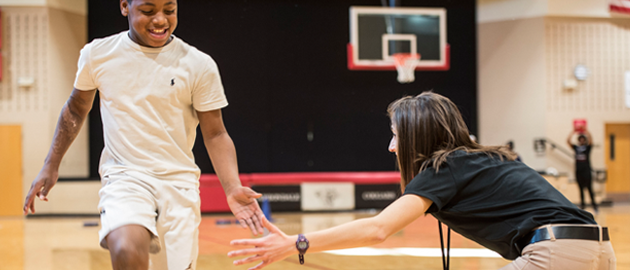 Student teacher high-fiving a student